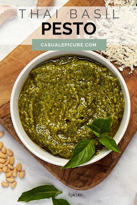 This Thai Basil Pesto combines the distinctive flavor of Thai basil with traditional pesto ingredients for a bold, flavorful sauce. Whether drizzling it over noodles, spreading it on sandwiches, or using it as a dip, this versatile pesto adds a vibrant Thai twist to any dish. Thai Basil Pesto, Marinades For Chicken, Classic Pesto Recipe, Freezing Pesto, Toasted Rice, Nut Free Pesto, Sandwiches And Wraps, Make Pesto, Assorted Nuts