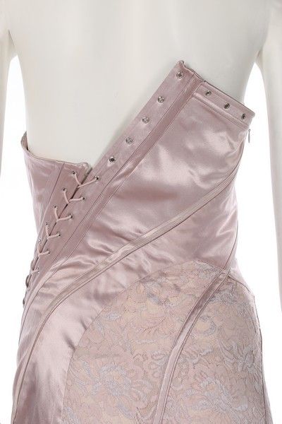 A John Galliano pink satin and lace gown, Spring-Summer 2000, labelled and UK size 12, the asymmetric corset-like bodice with diagonal lacing which continues down through the fish-tail skirt, bust 92cm, 36in, waist 66cm, 26in    This was look no. 12 on the catwalk. Bella Hadid wore an identical gown to the Bulgari perfume launch in Rome, 24th May 2017. John Galliano Corset, Corset Runway, Bulgari Perfume, Asymmetrical Corset, Corsets Fashion, Corset Lacing, Corset Design, Corset Skirt, Collection Couture