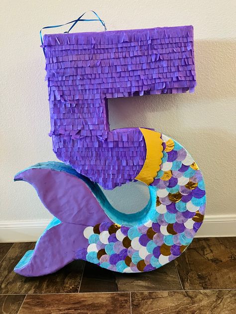 This is a mermaid themed piñata for a fifth birthday party. #piñata #mermaidpiñata #number5 #purple #sirenapiñata Fifth Birthday Party, Mermaid Pinata, Ariel Birthday Party, Ariel Party, Mermaid Birthday Decorations, Birthday Pinata, Mermaid Birthday Party Decorations, Mermaid Theme Birthday Party, Ariel Birthday