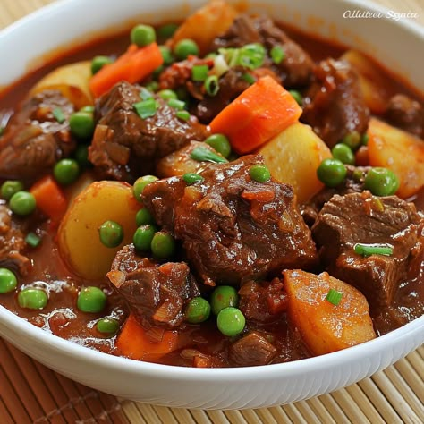 🥩 Indulge in our hearty Caldereta! 🍲✨ #BeefStew #FilipinoCuisine Caldereta (Filipino Beef Stew) Ingredients: Beef chunks (1 kg) Tomato sauce (1 cup) Green peas (1/2 cup) Carrot, sliced (1) Potato, diced (2) Bell pepper, sliced (1) Liver spread (2 tbsp) Garlic, minced (3 cloves) Onion, chopped (1) Soy sauce (2 tbsp) Bay leaves (2) Water (4 cups) Salt and pepper to taste Oil (2 tbsp) Instructions: Sauté garlic and onion in oil until fragrant. Add beef and brown on all sides. Pour in tomato ... Filipino Beef Stew, Beef Caldereta, Beef Chunks, Beef Stew Ingredients, Instagram Recipes, Trending Recipes, Green Peas, Bay Leaves, African Food