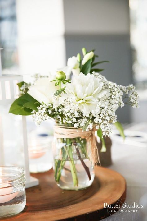 Simple table decor. Affordable and simple flower arrangement. #wedding #doljanchi #tabledecor #simpleflowers Ranunculus Wedding Centerpieces, White Mason Jars, Wedding Reception White, Jam Jar Flowers, White Flower Centerpieces, Mason Jar Flower Arrangements, Wedding Table Toppers, Wedding Jars, Wedding Centerpieces Mason Jars