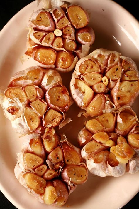 A plate with several bulbs of roasted garlic on it. Roasting Garlic Bulbs, Oven Roasted Garlic Bulbs, Roast Garlic Bulb, Roast Whole Garlic, Oven Roasted Garlic, Roasted Garlic Recipe, Roasting Garlic In Oven, Roast Garlic, Garlic Bulbs