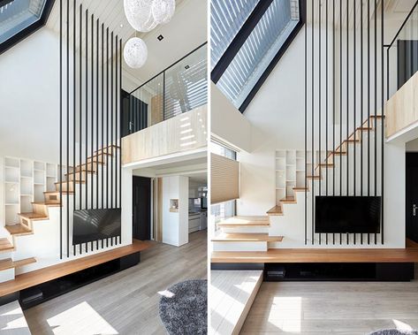 This modern apartment uses black poles to provide a safety element for the stairs, replacing the need for a handrail on the higher section. #Stairs #StairDesign #TVMount High Ceiling Living Room Modern, Loft Staircase, High Ceiling Living Room, Stairs In Living Room, Stairs Design Modern, Ceiling Design Living Room, Ceiling Design Modern, Minimalist Apartment, Modern Stairs