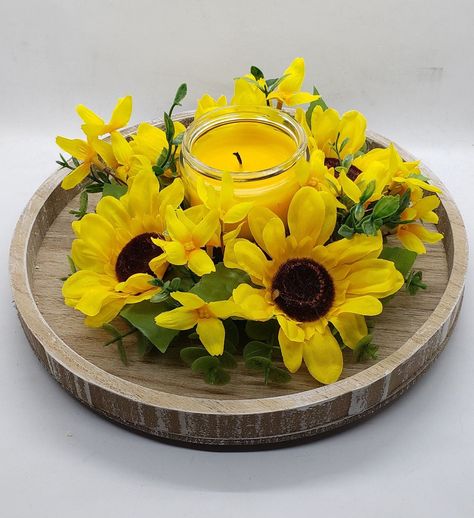 Brighten up your home decor with our delightful yellow sunflower faux flower candle ring, accented with charming yellow accent flowers and lush greenery. Designed to encircle 3-inch candles or smaller, this stunning botanical arrangement will add a touch of sunshine and warmth to any space. Simply place your favorite candle in the center of the ring to create a captivating centerpiece that radiates joy and happiness. Whether you're hosting a summer soiree or simply adding a pop of color to your Sunflower Candle, Floral Candle Rings, Favorite Candle, Accent Flowers, Sunflower Centerpieces, Sunflower Arrangements, Fun Fall Crafts, Candle Base, Candle Ring