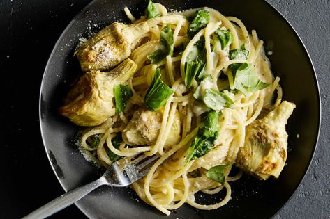 Lemon zest, lemon juice, Parmesan and basil come together for a silky and vibrant sauce that makes this weeknight-friendly pasta sing The addition of roasted artichoke hearts adds texture and complements the zestiness of the dish There’s no better time than a weeknight to embrace canned or frozen artichoke hearts, as they are immensely less work than whole fresh ones, and they roast beautifully — and effortlessly — in a hot oven Roasted Artichoke Hearts, Lemon Parmesan Pasta, Roasted Artichokes, Lemon Spaghetti, Roasted Artichoke, Artichoke Recipes, Parmesan Pasta, Nyt Cooking, Cooking Guide