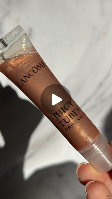 Naomi Mizrahi on Instagram: "So the juicy tube is going viral again… so excited to have this OG back in my life. Bronze heaven ⚡️👑🤎 @lancomeofficial juicy tube “ hallucination,” RRP £25 FYI these glosses are a little sticky (I like this) but if you don’t like sticky this gloss isn’t for you. Please do not use/repost my content without my permission. - - - #lipgloss #viralmakeup #makeup #makeupmacro #makeupunboxing #newmakeup #makeupinspo #makeuplover #cleargloss #lipglossjunkie #lipglossaddict #plumpinggloss #lipplumper #glittergloss #sparkle #shimmergloss #ukblogger #ukinfluencer #ukmakeup #lancome #lancomejuicytubes #juicytube" Lancome Juicy Tubes, Juicy Tubes, Uk Makeup, Glitter Gloss, Going Viral, Lip Plumper, Makeup Lover, Makeup Inspo, So Excited