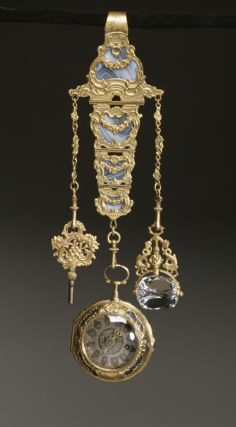 Chatelaine with Watch, 18th c, French, Gold, gilt metal, agate, rock crystal. The watch and chatelaine are decorated with elaborate scrollwork and garlands over beautifully striated agate. The chatelaine is fitted with a watch key and a revolving rock crystal seal, neither of which were likely made at the same time as the chatelaine and watch. Georgian Jewelry, Pendant Watches, Antique Clocks, Antique Watches, Chatelaine, Vermeil Jewelry, Victorian Jewelry, Emerald Jewelry, Rock Crystal