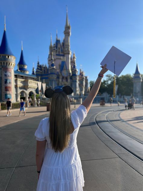 Girl wearing white dress holding graduation cap in air facing Cinderella castle in magic kingdom Disney Senior Photos, Disney Graduation Photos, Disney World Graduation Pictures, Disneyland Senior Pictures, Disneyland Senior Photos, Disney Graduation Pictures, Disney Grad Photos, Senior Pics At Disney World, Mainstreet Usa