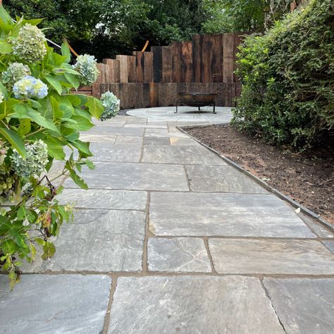 There are no two identical paving slabs, and Indian sandstone paving slabs are the most widely used to replicate the appearance of your garden or landscape due to its adaptability, strength, and longevity. They come in a variety of colours, styles, and sizes to produce a gorgeous backdrop that captures the personality of your house. Grey Sandstone Paving, Slate Patio Garden Ideas, Garden Paving Slabs Patio Ideas, Indian Sandstone Patio Ideas, Paving Slabs Ideas Patio, Sandstone Path, Paving Slabs Ideas, Indian Stone Patio, Garden Paving Ideas