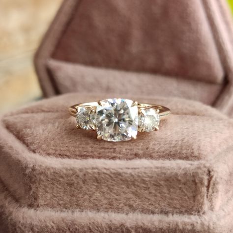 Vintage Three Stone Moissanite Diamond Engagement Ring 14k Yellow Gold Cathedral Setting 2 carat Cushion Cut Engagement Ring with Side Stone, 3 Stone Engagement Rings for Women, 2ct Cushion Cut Moissanite Ring, Three Stone Engagement Ring, Anniversary Ring Gift for Wife, Classic Wedding Ring, Unique Proposal Ring for Girlfriend, Moissanite Jewelry, Bridal Ring, Basket Setting Ring 💎 Center Moisanite Details 💎 ➤Shape: Cushion Cut Moissanite ➤Size: 2.00CT (approx.) ➤Measurement: 7.50x7.50mm ➤Main Stone Clarity: VVS1 ➤Color: D E F ➤Cut Grade: Excellent ➤Moissanite Guarantee: Test Positive By Thermal Diamond Testers & lifetime Brilliance ➤Hardness: Moissanite 9.25 💎 Side Moissanite Details 💎 ➤Shape: Round Cut Moissanite ➤Size: 0.70CTW (approx.) ➤Color: Colourless ➤Clarity: VVS 💍 Metals De Simple 3 Stone Engagement Rings, Cushion Engagement Ring With Side Stones, Unique Three Stone Engagement Rings, Vintage 3 Stone Engagement Rings, Triple Diamond Engagement Ring, Cushion Cut Three Stone Engagement Ring, 3 Stone Cushion Engagement Ring, Vintage Unique Engagement Rings, Vintage Cushion Cut Engagement Ring