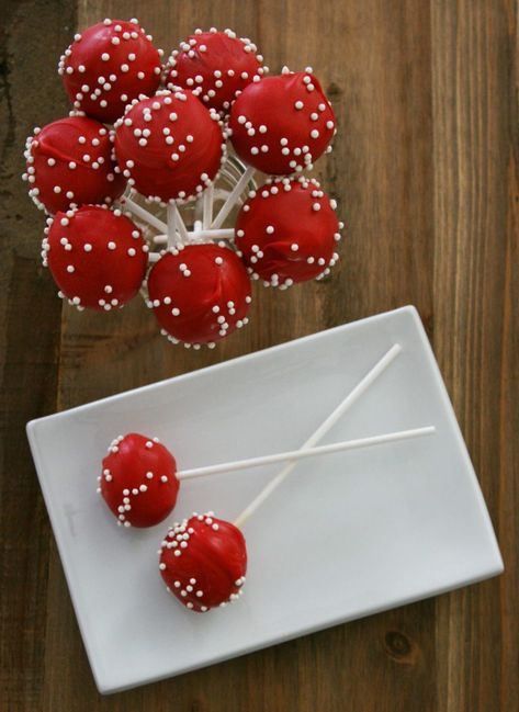 Cake pops are a delicious treat. They make great gifts, table toppers, stocking stuffers, or party favors. By changing the color and adding a few pearl sprinkles, cake pops are the perfect way to add a special touch to any get together. Visit www.makingmotherhoodmatter.com or click the link to exactly how to make my red velvet cake pop recipe, without having to buy any fancy gadgets. Red Party Snacks, Red Snacks For Party, Red Snacks For Color Party, Red Velvet Cake Pops Recipe, Red Treats, Red Cake Pops, Babycakes Cake Pop Maker, Cake Pops Recipe, Red Velvet Cake Pops