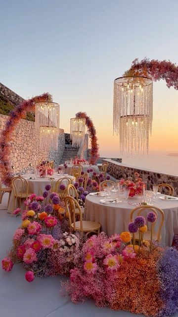 Τie the Knot | Maria Sila on Instagram: "Don't miss that magic sunset at the end of the video ! The colors of a summer wedding⛱️ Planning & design: @tietheknotsantorini  Flower design: @bloom_de_fleur_santorini  Lighting installations: @santorinievents  Tablescape: @maisontrilogie  Venue: @elvientosantorini  Chairs: @spicy_bites_catering_rentals  Candles: @idea.candles  #destinationwedding #summerwedding #greecewedding #italywedding" Coachella Decor, Sunset Colored Wedding, Sunset Themed Wedding, Wedding Theme Ideas Elegant, Sangeet Theme, Mandap Setup, Sunset Wedding Colors, Wedding Venue Flowers, Sangria Wedding