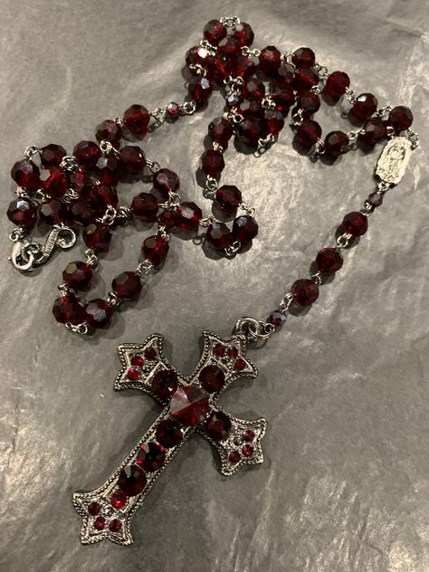 Black plated,  beautiful ruby red Siam crystal rosary.  It does have a clasp so that you can wear it in many ways, including a layered look. The cross pendant like all of my rosary necklaces has crystals on both sides so if it turns you see crystals on either side. Also, all my jewelry is hypoallergenic. Red Rosary, Rosary Style Necklace, Red Pomegranate, Rosary Necklace, Red Jewelry, Funky Jewelry, Jewelry Lookbook, Cross Jewelry, Fantasy Jewelry