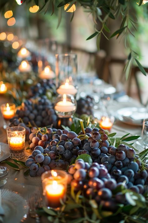 ✨ Elevate your wedding ambiance with a centerpiece that whisks you away to the rolling hills of Tuscany. Experience the charm of Italy as grape vines & olive branches intertwine with the warm glow of candles on your special day. #WeddingInspiration #TuscanWedding #RomanticDecor #WeddingIdeas #CountryChic #RusticElegance #GrapeAndOlive #CandlelightMagic Let the light guide your love story. Vine Table Decor, Italian Inspired Centerpieces, Wine Dinner Centerpieces, Wine Cork Table Decor, Grapes Centerpiece Wedding, Tuscany Wedding Table Decor, Grape Centerpiece Wedding, Grape Wedding Decor, Italian Centerpieces Table Decorations Tuscan Style