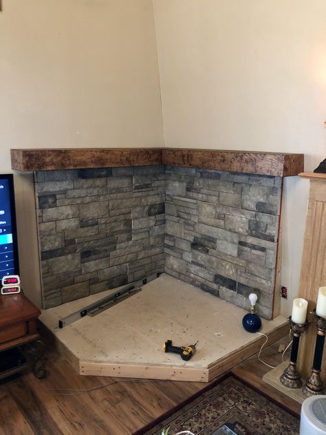 Wood Stove Mantle Corner, Stone Surround Wood Stove, River Rock Behind Woodstove, Tv And Wood Stove Layout, Wood Stove With Curved Pipe, Wood Burning Stove Basement, Farmhouse Living Room With Wood Stove, Woodstove Backing Ideas, Rock Wall Behind Wood Stove