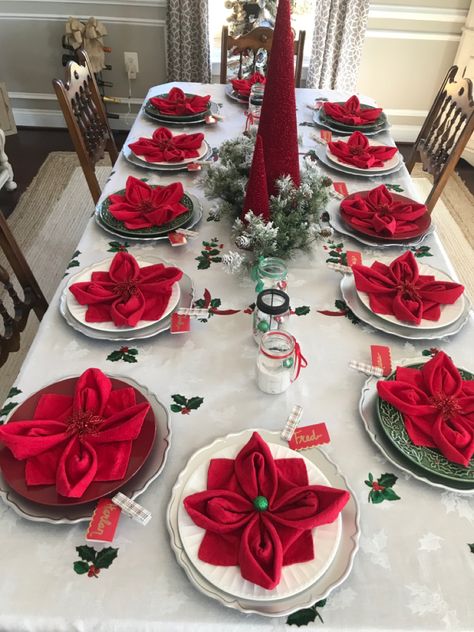 Setting the Christmas table can be as easy as folding your napkins into poinsettia flowers. And they’re easy to make! Napkin Folding For Christmas Table, Best Christmas Table Decorations, Napkin Cloth Folding, Napkins Folding Ideas Christmas, Napkin Ideas For Christmas, Christmas Napkin Decorations, How To Fold Dinner Napkins Holidays, Christmas Dinner Napkins, Folding Cloth Napkins For Christmas