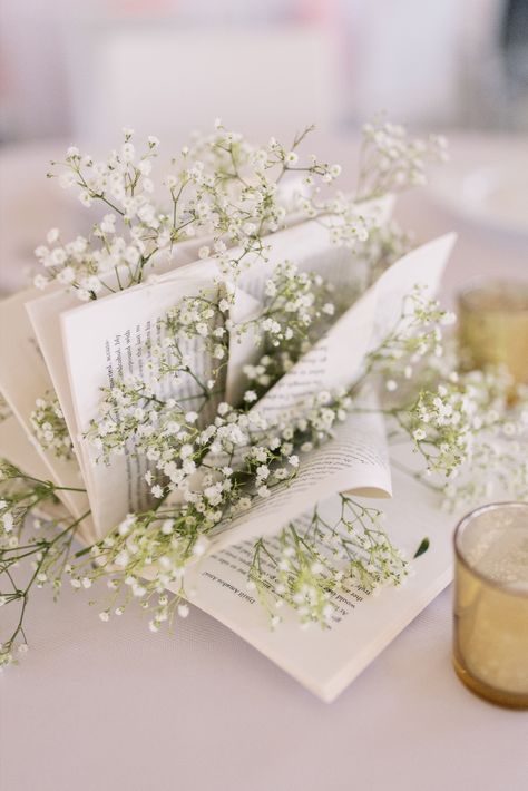 Use books for centerpieces for a unique personal touch at your reception! | Photography by Emma Farr Photography Book Decor For Wedding, Book Bridal Shower Theme Centerpieces, Unique Graduation Centerpieces, Book Themed Wedding Centerpieces, Baby Shower Book Centerpieces, Book Themed Wedding Shower Ideas, Book Lover Wedding Ideas, Book Centerpiece Wedding, Book Centerpiece Ideas