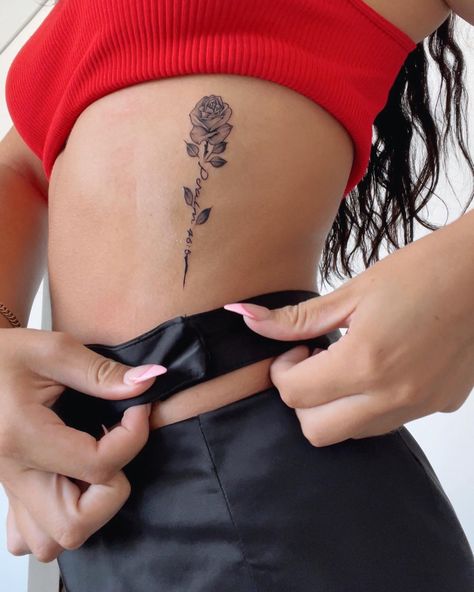 Psalm 46:5 on ribs. Detailed rose tattoo. Rose With Bible Verse Tattoo, Rose Tattoos Ribs, Rose Side Rib Tattoo, Rose Bible Verse Tattoo, Cute Tattoos On Ribs, Name In A Rose Tattoo, Rib Rose Tattoos For Women, Rose Tattoo On Waist, Bible Verse Tattoos On Ribs