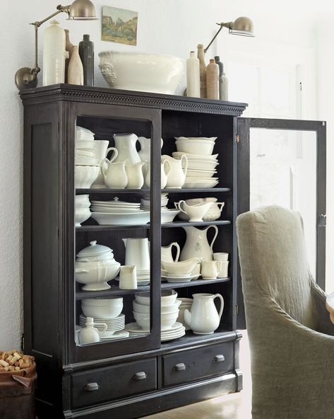 a black cabinet with white dishware Black China Cabinet, French Vintage Home Decor, Home Decor Websites, Black China, Eclectic Farmhouse, Living Room Upholstery, Airy Room, Beach Cottage Decor, Mid Century Dining Chairs