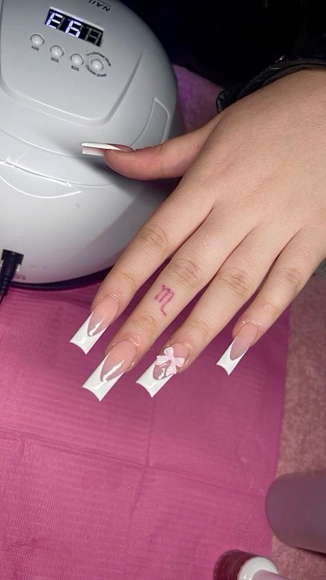 White French Tip Nails With Bow Charm, Prom Frenchies, Acrylic Nails Bow Charm, Bow Acrylic Nails French Tip, Bow Nail Charm, White French Nails With Charms, Long French Tip Nails With Charms, French Tip Nails With Bow Charm, Acrylic Nails With Bow Charms