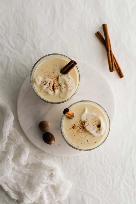 Two glasses of homemade eggnog on a white round marble. What Is Eggnog, Eggnog Ice Cream, Eggnog Recipe Homemade, Eggnog Latte, Custard Ice Cream, Mini Pavlova, Vietnamese Iced Coffee, Homemade Eggnog, Batch Cocktails