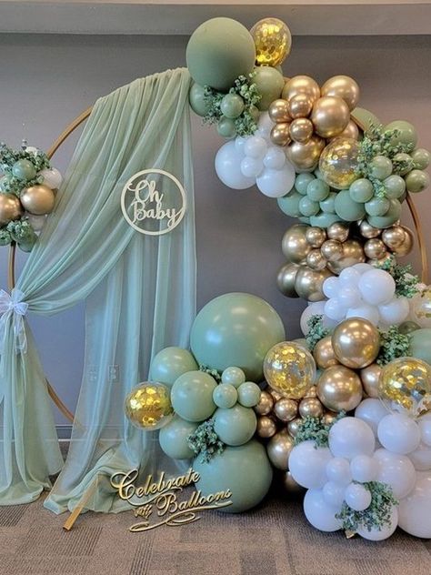 Discover 25 stunning sage green baby shower ideas featuring elegant balloon arches, modern backdrops, and dreamy decor. Get inspired by these Pinterest-worthy setups for your special day! Gold And Green Baby Shower Ideas, Sage And Cream Baby Shower Ideas, St Pattys Day Baby Shower Ideas, Green Themed Baby Shower Ideas, Baby Shower Purple Theme, Sage Baby Shower Decor, Pink And Green Gender Reveal, Sage Green And Gold Baby Shower Ideas, Diy Baby Shower Decoration Ideas