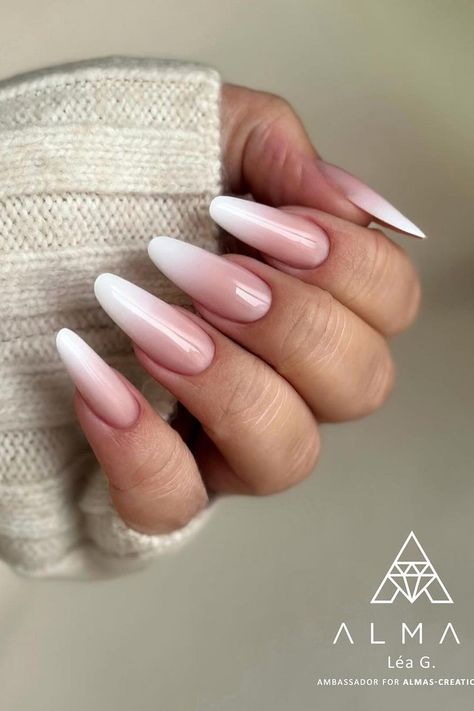 Elegance meets simplicity in this manicure featuring long, almond-shaped nails. The nails are painted with a graceful ombre transitioning from a soft pink at the base to a milky white tip, exuding a classic and refined look perfect for any occasion.  // Photo Credit: Instagram @latelieroboutdesongles Soft Pink Nail Designs, Pink And White Ombre Nails Almond Matte, Nails Ombre Almond, Long Almond Nail Designs, Pink And White Ombré Almond Nails, French Ombre Nails Almond, Almond Baby Boomer Nails, Pink And White Ombre Nails Almond Shape, Pink To White Ombre Nails Almond