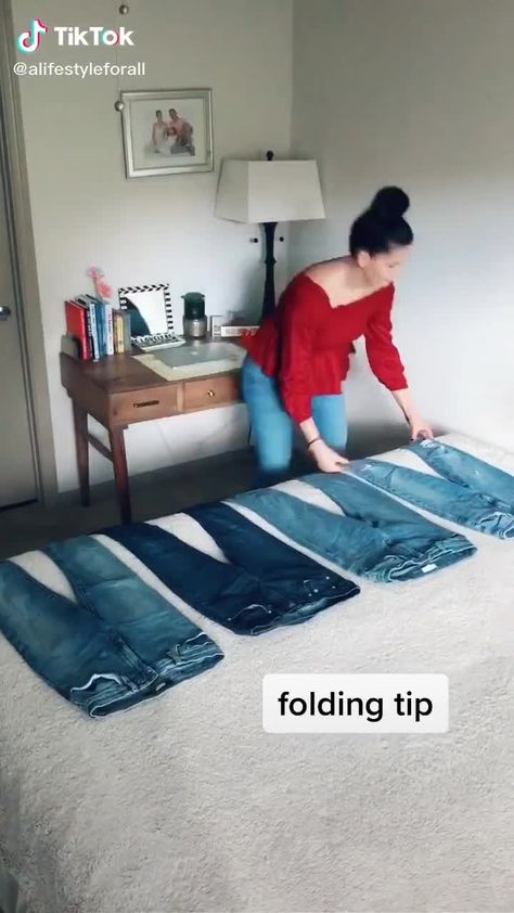 This is an image Jeans Folding Ideas, How To Fold Overalls To Save Space, Loss Jeans Hacks, Folding Jeans On Hanger, How To Fold Jeans For Shelf, How To Store Jeans In Closet, Pants Hacks Jeans Fold, Clothing Folding, Fold Pants