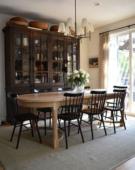 Modern Traditional dining room with oak table and black chairs. Layers of vintage pieces make this intentional space really shine. #warmdiningroom #cozyandwarm Modern Traditional Dining, Modern Traditional Dining Room, Warm Dining Room, Cottage Dining Rooms, Black Dining Room Chairs, Dining Room Inspo, Hillside House, Dining Room Hutch, Black Dining Chairs