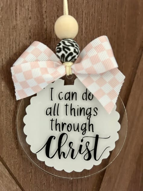 This adorable "I can do all things through Christ" car charm/rearview mirror charm is the perfect vehicle accessory and also the perfect reminder as you travel about your day!! 💕 Product comes with the following: cream color durable nylon - standard 25" from end to end  1 wood bead 1 silicone bead 3" acrylic disc pink/white checkered print bow white vinyl on back/black vinyl lettering on front *nylon cord is adjustable to suit your personal preference by tying knot at the desired length.   *this is a single sided car charm - back has white scalloped vinyl CAUTION:  Many items in this shop contain small parts and potentially present a choking hazard.  Please never allow children unattended while using these products.  All of my products should be used with adult supervision.  The buyer ass Things To Make With Vinyl, Car Hangers Rear View Mirror, Acrylic Car Charms Rear View Mirror, Rearview Mirror Decoration Diy, Homemade Charms, Car Mirror Charms, Badge Reels Diy, Acrylic Tags, Car Hanging Accessories