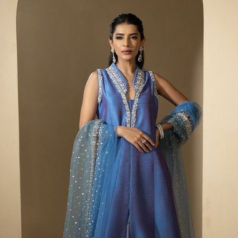 FARIDA HASAN on Instagram: "Straight out of a dream- the most flattering silhouette cut in two tone blue silk is embellished with a burst of sequined on the hem (front and back) neckline and sleeves. Comes with a silk lehnga.

AVAILABLE ONLINE

For queries and orders, inbox or call/WhatsApp us at +92-305-5555208.
#FaridaHasan #FHStudio #FHPret #Fêtedeslumières #FestiveEdit #Fashion #Designerwear #Readytowear #IntimateWeddings #FestiveWear #OccasionWear #Embroidery #Craftsmanship #Traditional #Classic #womenswear" Fatima Effendi Dresses, Floor-length Resham Embroidered Kaftan, Farida Hasan, Festive Semi-stitched Embroidered Kaftan, Evening V-neck Embroidered Kaftan, Blue Embellished V-neck Kaftan, Blue Silk, Call Whatsapp, Silhouette Cut