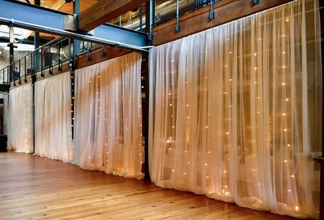 Sheer fabric draping backed by vertical market light strands installed by Get Lit at Bay 7 (Angus Barn). Room Seperator, Shed Wedding, Wall Drapes, Waterfall Lights, Bridal Suit, Fabric Ceiling, Fabric Draping, Fabric Wall Decor, Market Lighting