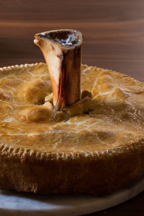 This lavish, British-style meat pie is a delicious, time-consuming project It comes together over many hours, layering the flavors and textures of many different meats, and seals it all in a buttery homemade dough The recipe belongs to the chef Angie Mar of the Beatrice Inn in New York, who makes the pie at her restaurant in smaller ramekins, so that each person gets her own marrow bone Venison Meat, Homemade Dough, Nyt Cooking, Bone Marrow, Meat Pie, Trotter, Pie Plate, Deep Dish, Pie Filling