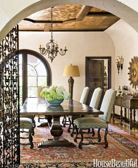 The dining room is bathed in a blushed peach that gives the room a twilight aura "and really flatters the complexion," Callaway says. Woodwork is painted in faux grained walnut. Country Trestle table, Emanuel Morez. Barcelona dining chairs by Panache Designs, covered in a Kravet fabric. Antique Pakistani rug. Colonial Revival House, Spanish Colonial Homes, Mediterranean Revival, Spanish Decor, Colonial Interior, 1920s House, Colonial Style Homes, Mediterranean Home Decor, Spanish Style Home