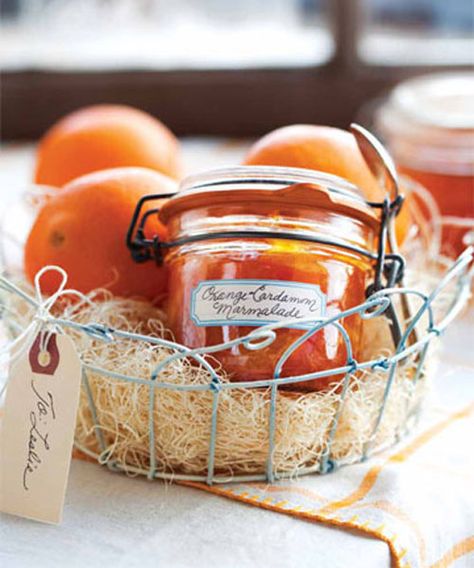 This Orange-Cardamom  marmalade can be spooned over buttered toast, spread on a brioche roll or croissant, or dolloped on a toasted English muffin spread with fresh goat cheese. Plus, sealed, it will keep for up to one year. Include it in a wire basket with gift basket filler and fresh oranges. Diy Christmas Baskets, Orange Cardamom, Brioche Rolls, Marmalade Recipe, Diy Gift Baskets, Christmas Baskets, Oranges And Lemons, Jams & Jellies, Marmalade