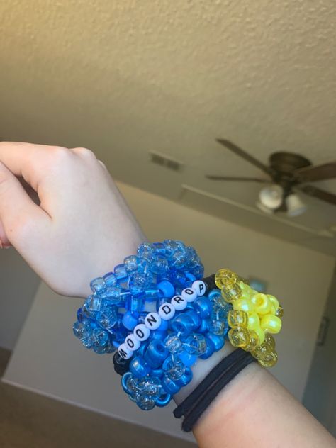 blue rotator kandi cuff with yellow star and “moondrop” on the rotating part. Kandi Star Cuff, Fnaf Kandi, Blue Kandi, Kandi Star, Kandi Beads, Kandi Cuffs, Kandi Kid, Kandi Ideas, Kandi Cuff