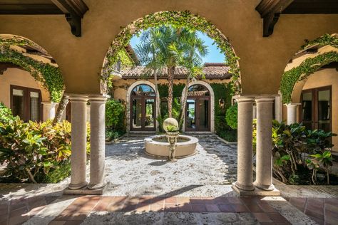 Ivy-covered archways Miami Spanish Style Home, One Level Spanish Style Homes, Spanish Compound House, Meddertarian House, Spanish Elevation Design, Spanish Colonial Mansion, Ivy Covered Mansion, Beautiful Courtyards, Old Spanish Style Homes