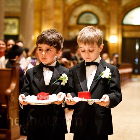 The two ring bearers, Chelsea’s cousins, wore black tuxedos and carried  the rings in red boxes  on silver platters. Magical Mansion, Grooms Tuxedo, Red Christmas Wedding, Black White And Gold Wedding, Ring Bearer Boxes, Ring Bearer Ideas, White Gold Ruby Ring, Ring Bearer Outfits, Wedding Outfit For Boys