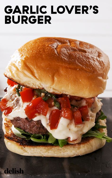 This burger was MADE for garlic lovers. Get the recipe at Delish.com. #recipe #easy #easyrecipes #delish #garlic #burger #hamburger #tomatoes #groundbeef #beef #sandwich #basil #cheese #mozzarella #parmesan Garlic Burgers Recipe, Garlic Burgers, Garlic Burger Recipe, Best Burger Recipe, Hamburger Recipes, God Mat, Good Burger, Burger Recipes, Wrap Sandwiches