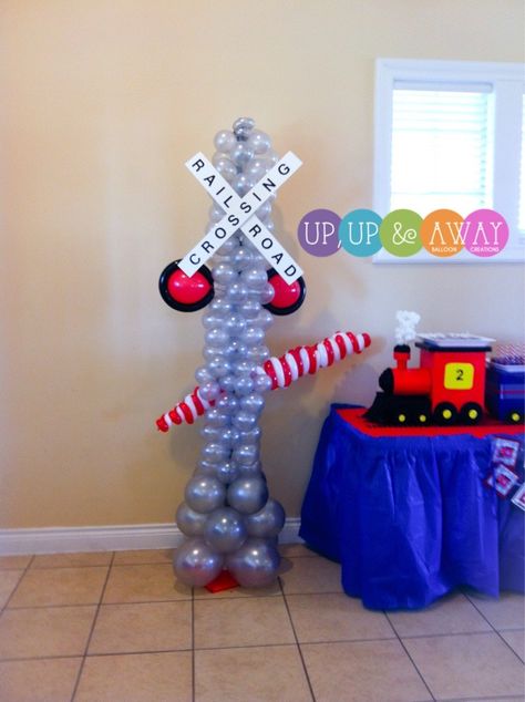 Custom made rail road crossing balloon columns. Polar Express Balloon Garland, Polar Express Balloons, Polar Express Balloon Arch, Balloon Train, Santa Brunch, Train Theme Party, Polar Express Christmas Party, Balloon Training, Train Theme Birthday Party