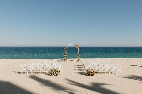 beachfront wedding ceremony, floral wedding arch, ocean view wedding, beach wedding setup, Garza Blanca wedding, Los Cabos destination wedding, outdoor wedding decor, elegant beach wedding, simple wedding arch, white chiavari chairs, seaside wedding inspiration, floral ceremony decor, romantic beach ceremony Wedding Arch White, Beach Wedding Setup, Simple Wedding Arch, Floral Wedding Arch, Ocean View Wedding, Floral Ceremony, Outdoor Wedding Decor, Elegant Beach Wedding, Beachfront Wedding