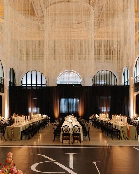 Dreamy wedding reception setup featuring elegant black infinity chairs, modern linens, lux tableware, custom signage and lush florals dotted with moody candles and jazz-club lamps. All this under a twinkly 24 foot wide gold chandelier. Perfectly capturing the chic, speakeasy feel that N&R love. photographer: @joshua_kane_photography Moody Candles, Dreamy Wedding Reception, Wedding Reception Setup, Joshua Kane, Speakeasy Wedding, R Love, Jazz Club, Custom Signage, Gold Chandelier