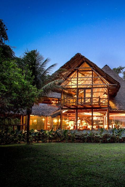 The Inkaterra Reserva Amazonica lodge lit-up at night in Puerto Maldonado, Peru Amazon Rainforest Travel, Brazil Amazon Rainforest, Brazil Rainforest, Peru Amazon, Peru Itinerary, Puerto Maldonado, Brazil Amazon, Eco Resort, Womens Retreat