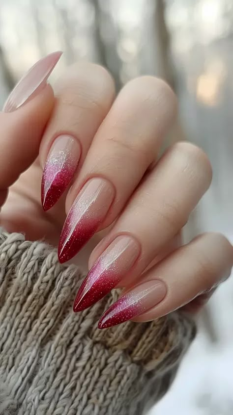 The image shows a hand with long, stiletto-shaped nails. The nails are painted with a red and silver glitter ombre design ->> more details in ai-img-gen.com Red Ombre Nails Design, Ombre Nails Glitter Red, Red Modern Nails, Red Nail With Glitter, Gel X Red Nails, Red Nail Ombre, Red Detail Nails, Red And Silver Glitter Nails, Ombre Nails Almond Shape