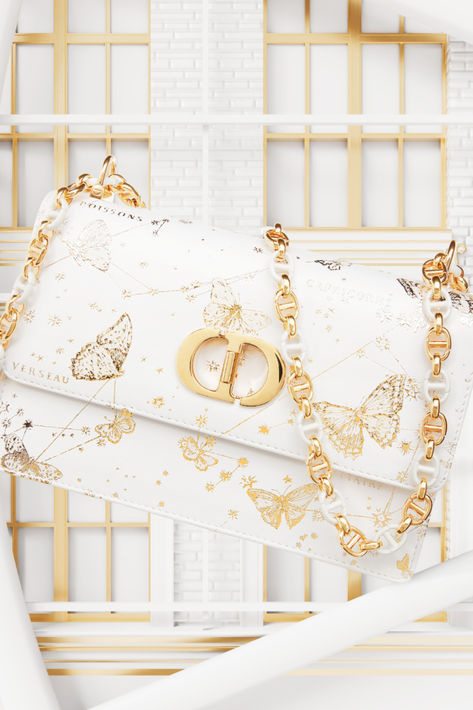 Indulge in a selection of Dior creations available at Saks featuring iconic pieces like the Dior Saddle Bag, Dior Book Tote Bag, Walk'n’Dior sneakers, delicate jewelry and silk accessories, all adorned with a reimagined toile de Jouy motif featuring golden butterflies from Maria Grazia Chiuri's Dior Cruise 2024. © Gourau Phong Dior Bag Aesthetic, Luxury Bags With Gold Embroidery, Dior Art Bag, Dior Butterfly, Bougie Closet, Dior Cruise 2024, Dior Butterfly Bag, Dior Holiday, Dior Limited Edition Bag