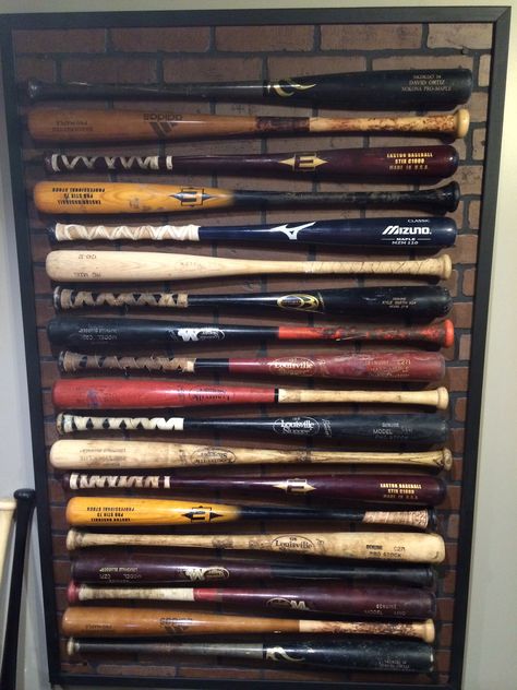 Baseball bats mounted to a laminate piece of wall. Displays my husbands used bats. Sports Room Man Cave, Baseball Bat Display, Bat Display, Baseball Bedroom, Bat Decorations, Baseball Wall, Bat Wall, Walton Family, Wall Displays