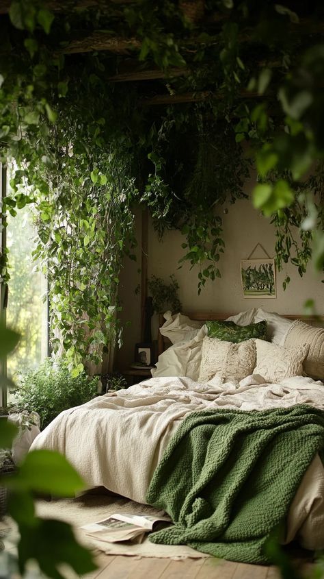 Transform your bedroom into a serene oasis with a stunning indoor garden vibe that invites tranquility and relaxation. This style emphasizes the use of lush greenery, creating a connection to nature right from the comfort of your home. To achieve this look, start by incorporating a variety of indoor plants—think hanging vines, ferns, and leafy potted plants that can thrive in low light. Opt for a neutral color palette for your bedding, complemented by a cozy green throw to coordinate with the lu Low Lighting Bedroom, Cozy Forest Bedroom, Bedroom With Plants Aesthetic, Tropical Cottagecore, Vines In Bedroom, Plant Bedroom, Nature Inspired Bedroom, Hanging Vines, Green Throw