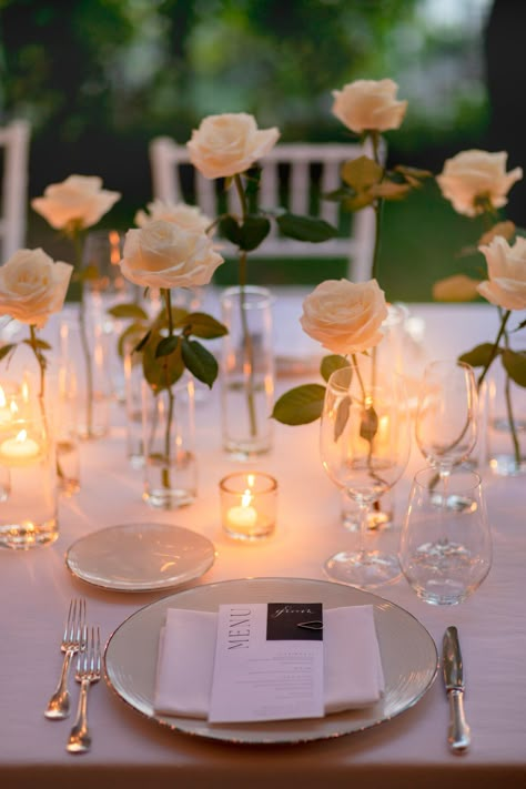 White roses and flickery candles set up for romantic reception in Hotel Caruso's olive garden, Amalfi Coast wedding All White Wedding Reception Romantic, Romantic Round Table Setting Wedding, Simple Rose Centerpiece Wedding, Roses And Candles Wedding, Belmond Hotel Caruso, Brazil Wedding, Rose Centerpieces Wedding, Candle Light Wedding, Romantic Reception