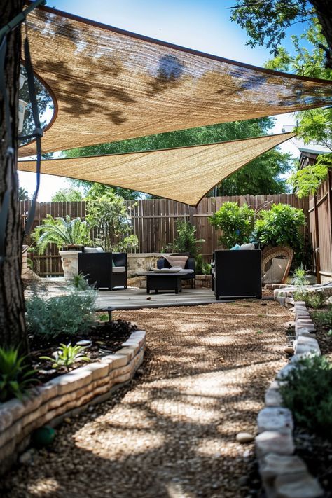 Backyard patio with shade sails, outdoor furniture, and lush greenery, creating a cozy, shaded area for relaxation and gatherings. Outdoor Sails For Shade, African Backyard Ideas, Diy Yard Seating, No Shade Backyard Ideas, Easy Shade Ideas For Backyard, Ideas For Shade In Backyard, Rooftop Shade Ideas, Creative Shade Ideas Outdoor, Shaded Garden Ideas Backyards