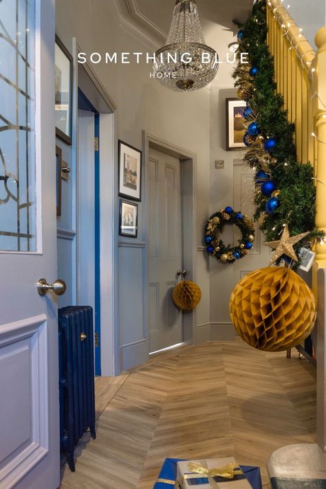 Looking to add some Christmas decor to add coziness to your home this festive season? Check out this beautiful entryway with hanging decor pieces and wreaths complimented by blue and gold Christmas baubles. A warm and inviting space that combines the warm nostalgia of Christmas time with modern hand selected home decor pieces. Aesthetic Entryway, Cozy Christmas Aesthetic, Blue And Gold Christmas, Festive Decor Ideas, Beautiful Entryways, Cabinet Paint Colors, Sustainable Decor, Blue Home, Festive Decor